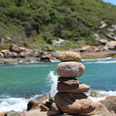 A stack of perfectly balanced stones in a calm setting.